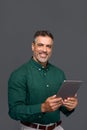 Happy middle aged business man using digital tablet, isolated, portrait. Royalty Free Stock Photo