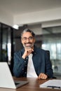 Happy middle aged business man working on laptop in office, vertical portrait. Royalty Free Stock Photo