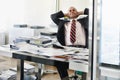 Happy middle aged businessman at office desk taking break from work Royalty Free Stock Photo