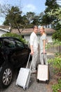 Happy middle-aged couple coming back home from travel Royalty Free Stock Photo