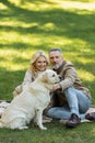 happy middle aged couple cuddling labrador Royalty Free Stock Photo