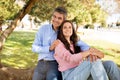 Happy Middle Aged Couple Embracing While Relaxing Outdoors In Park Royalty Free Stock Photo
