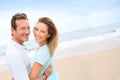 Happy middle-aged couple enjoying on the beach