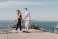 Happy Middle aged couple or friends practicing nordic walking in park near sea. Mature couple with trekking poles Royalty Free Stock Photo
