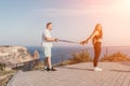 Happy Middle aged couple or friends practicing nordic walking in park near sea. Mature couple with trekking poles Royalty Free Stock Photo