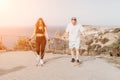 Happy Middle aged couple or friends practicing nordic walking in park near sea. Mature couple with trekking poles Royalty Free Stock Photo