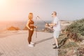 Happy Middle aged couple or friends practicing nordic walking in park near sea. Mature couple with trekking poles Royalty Free Stock Photo