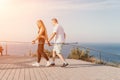 Happy Middle aged couple or friends practicing nordic walking in park near sea. Mature couple with trekking poles Royalty Free Stock Photo