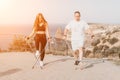 Happy Middle aged couple or friends practicing nordic walking in park near sea. Mature couple with trekking poles Royalty Free Stock Photo