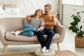 Happy Middle Aged Couple Hugging Relaxing On Sofa At Home Royalty Free Stock Photo