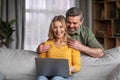 Happy Middle Aged Couple With Laptop Having Fun Together At Home Royalty Free Stock Photo