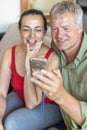 Happy middle-aged couple looking a mobile phone Royalty Free Stock Photo