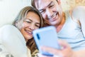 Happy middle-aged couple looking at mobile smiling. Royalty Free Stock Photo