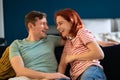 Young couple in love happily laughing, smiling. Entertainment, funny, amusing pastime together