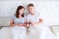 Happy middle aged couple smiling and chating on mobile phone in bedroom, smile people Royalty Free Stock Photo
