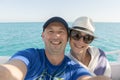 Happy middle aged couple taking selfie on yacht. Beautiful happy couple taking selfie on yacht deck floating in sea. Sailing, Royalty Free Stock Photo