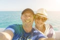 Happy middle aged couple taking selfie on yacht. Beautiful happy couple taking selfie on yacht deck floating in sea Royalty Free Stock Photo