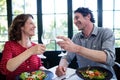 Happy middle-aged couple toasting champagne flutes while having lunch Royalty Free Stock Photo