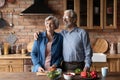 Happy middle aged family couple dreaming, distracted from preparing food. Royalty Free Stock Photo