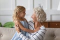 Happy middle aged grandmother holding on lap cute small granddaughter. Royalty Free Stock Photo