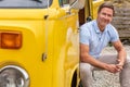 Happy Middle Aged Man Drinking Sitting In Van Doorway Royalty Free Stock Photo