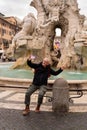 happy middle aged man on vacation taking a selfie in front of the fountain in piazza navona in rome Royalty Free Stock Photo