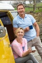 Happy Middle Aged Man and Woman Couple With Camper Van Bus Royalty Free Stock Photo