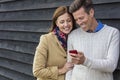Happy Middle Aged Man Woman Couple Using Cell Mobile Phone Royalty Free Stock Photo