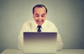 Happy middle aged man working on a laptop in his office Royalty Free Stock Photo