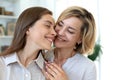 Happy middle aged mother and daughter talking on sofa in living room Royalty Free Stock Photo