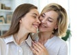 Happy middle aged mother and daughter talking on sofa in living room Royalty Free Stock Photo