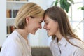 Happy middle aged mother and daughter talking on sofa in living room Royalty Free Stock Photo