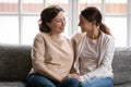 Happy middle aged mother and grownup daughter holding hands Royalty Free Stock Photo