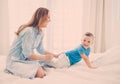 Happy middle aged mother with her child in a bed Royalty Free Stock Photo