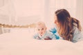 Happy middle aged mother with her child in a bed Royalty Free Stock Photo