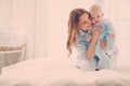 Happy middle aged mother with her child in a bed Royalty Free Stock Photo