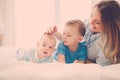 Happy middle aged mother with her children in a bed Royalty Free Stock Photo