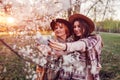 Senior mother and her adult daughter hugging and taking selfie in blooming garden. Mother`s day concept. Family values Royalty Free Stock Photo