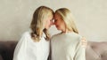 Happy middle aged mother hugging adult daughter looking at each other together at home Royalty Free Stock Photo