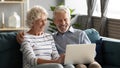 Happy middle aged older retired family couple using computer. Royalty Free Stock Photo
