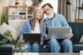 Happy middle aged older retired family couple using computer applications Royalty Free Stock Photo