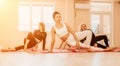 Happy middle aged well looking women, performing fascia exercises on floor using massage foam roller - tool to relieve Royalty Free Stock Photo