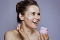 happy woman with cosmetic cream jar Royalty Free Stock Photo