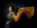 Happy middle-aged woman in a gray dress with a blue and yellow shawl Royalty Free Stock Photo