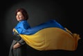 Happy middle-aged woman in a gray dress with a blue and yellow shawl Royalty Free Stock Photo