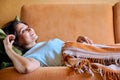 Happy middle aged woman lying on sofa at home Royalty Free Stock Photo