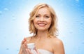 Happy middle aged woman with moisturizing cream Royalty Free Stock Photo