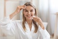 Happy middle aged woman removing make up, using cotton pads Royalty Free Stock Photo