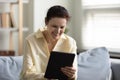 Happy middle aged woman using digital computer tablet. Royalty Free Stock Photo