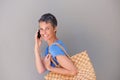 Happy middle aged woman walking and talking on mobile phone Royalty Free Stock Photo